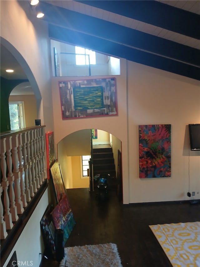 interior space with vaulted ceiling with beams, dark wood-type flooring, and wooden ceiling