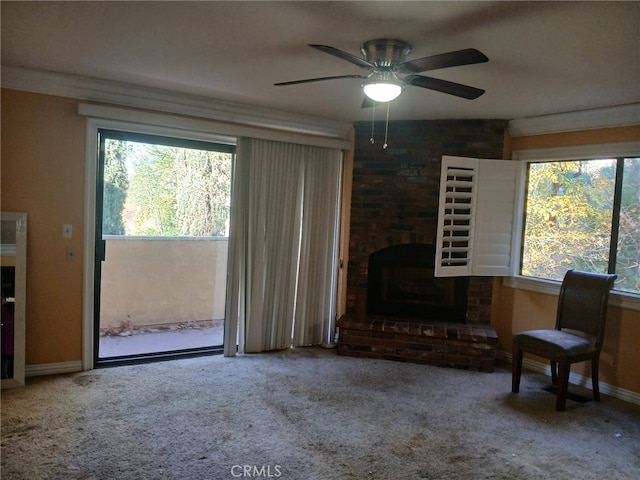 carpeted living room featuring ceiling fan and a brick fireplace