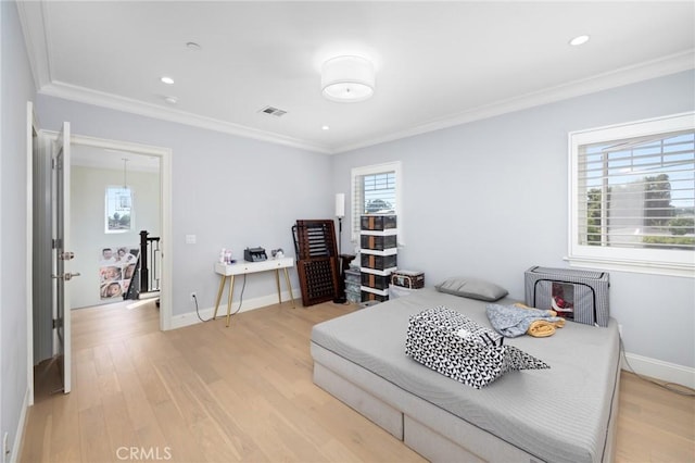 bedroom featuring light hardwood / wood-style floors and ornamental molding