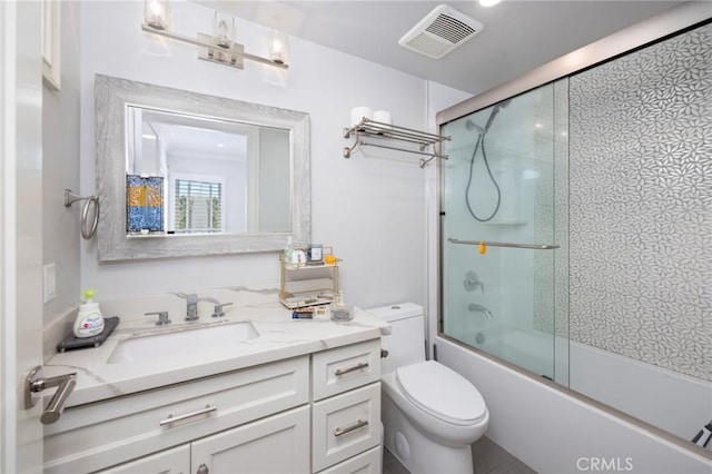 full bathroom with toilet, combined bath / shower with glass door, and vanity