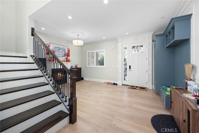 entryway with a chandelier and light hardwood / wood-style flooring