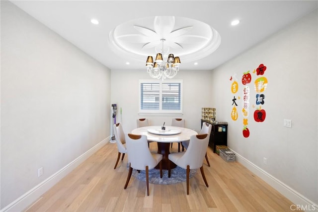 dining space with a chandelier and light hardwood / wood-style floors