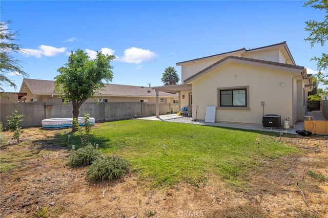 back of property featuring central AC, a patio area, and a lawn