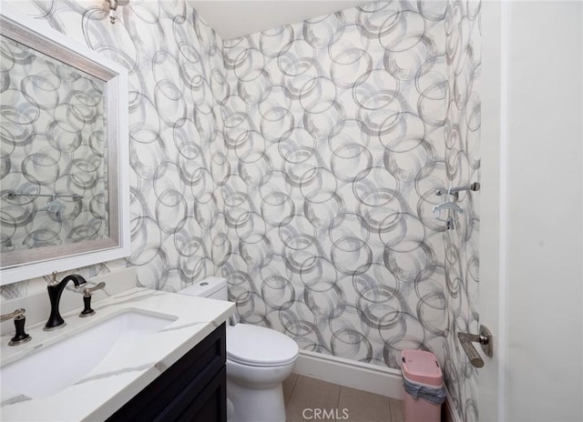 bathroom with tile patterned flooring, vanity, and toilet