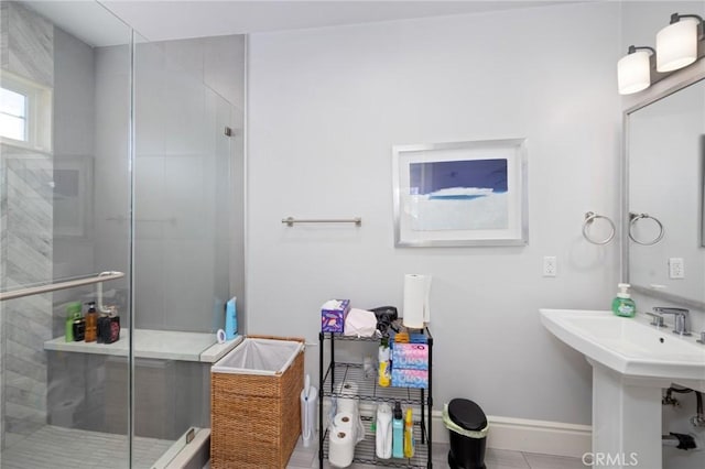 bathroom featuring tile patterned floors, walk in shower, and sink