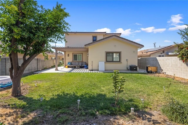 rear view of house with a yard and a patio