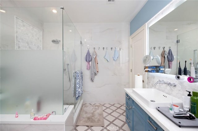 bathroom with vanity and a shower with shower door