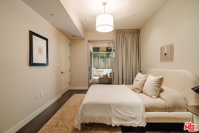 bedroom with dark hardwood / wood-style floors