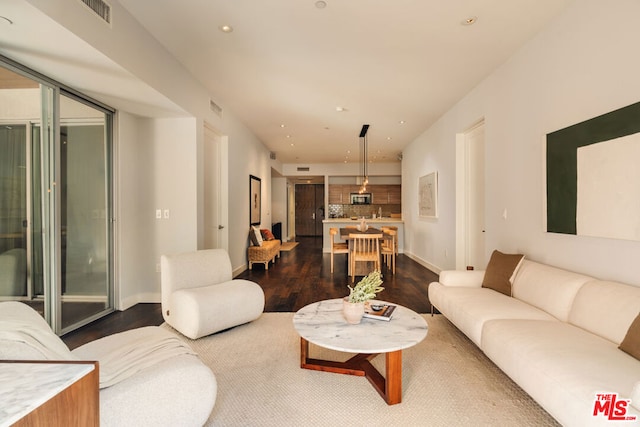 living room featuring dark wood-type flooring