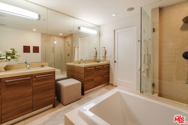 bathroom with shower with separate bathtub, vanity, and tile patterned floors