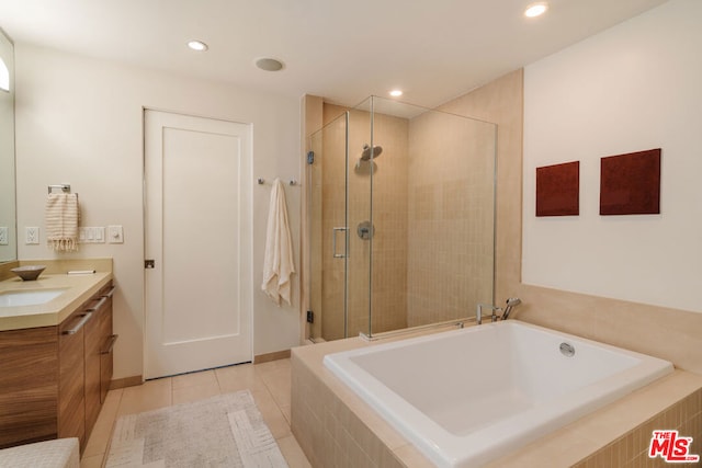 bathroom featuring tile patterned flooring, vanity, and plus walk in shower