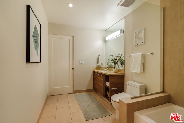 bathroom featuring tile patterned floors, a tub, vanity, and toilet