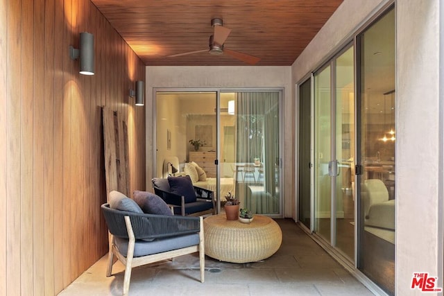 sunroom / solarium featuring ceiling fan and wood ceiling