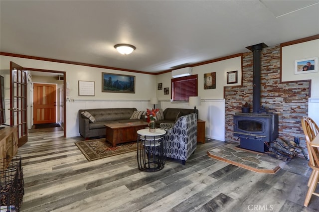 living room featuring a wall unit AC, a wood stove, and dark wood-type flooring