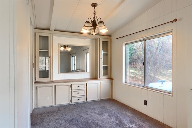 bathroom with vaulted ceiling and an inviting chandelier