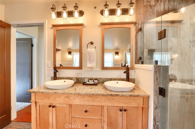 bathroom featuring vanity and a shower with shower door