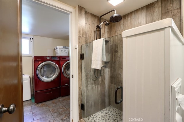 bathroom featuring independent washer and dryer and an enclosed shower