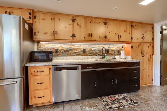 kitchen with backsplash, sink, and appliances with stainless steel finishes