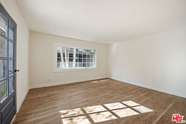 unfurnished room featuring light hardwood / wood-style flooring