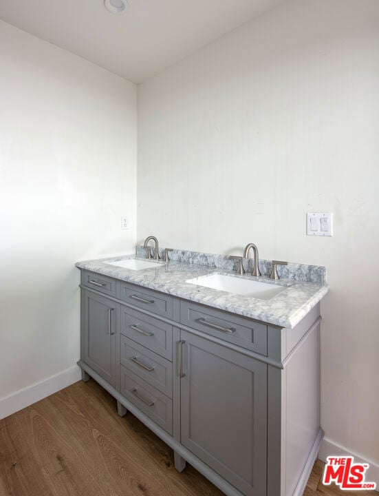 bathroom with vanity and hardwood / wood-style flooring