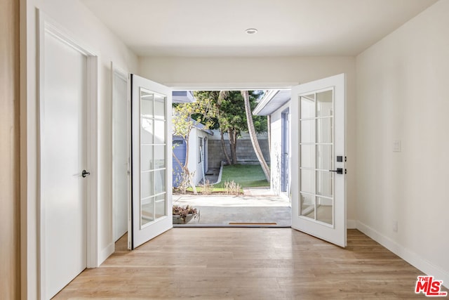 entryway featuring french doors and light hardwood / wood-style flooring