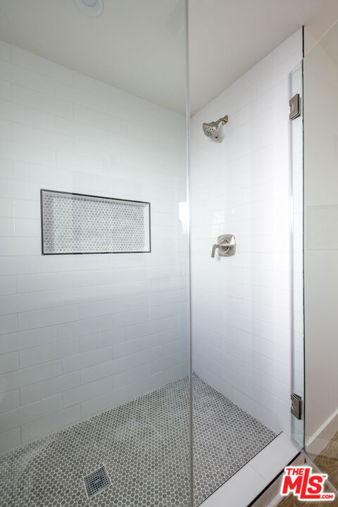 bathroom with tiled shower