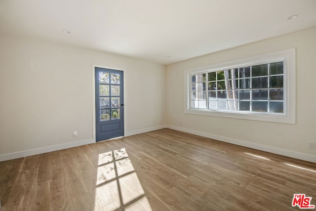 spare room with hardwood / wood-style flooring