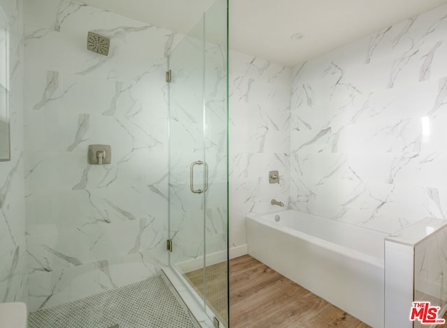 bathroom featuring wood-type flooring and separate shower and tub