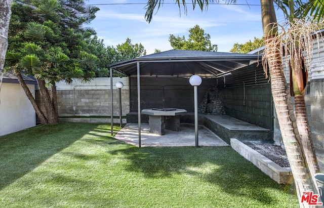 view of yard with a patio and a fire pit