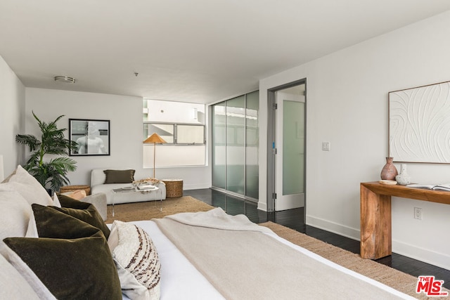 bedroom with dark wood-type flooring