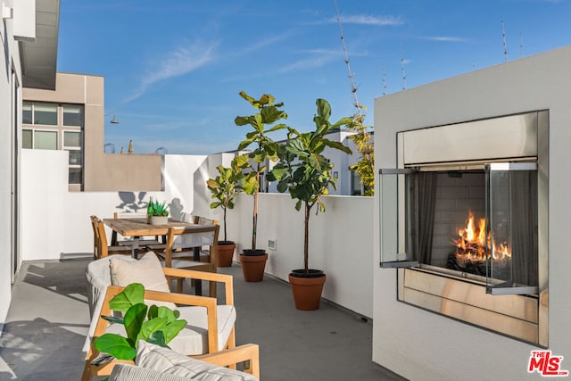 view of patio featuring exterior fireplace