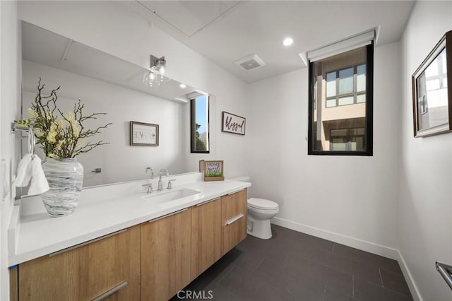 bathroom featuring tile patterned flooring, vanity, and toilet