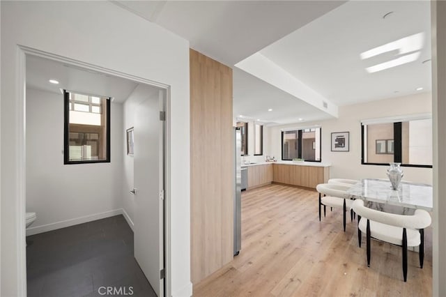 corridor with light hardwood / wood-style floors