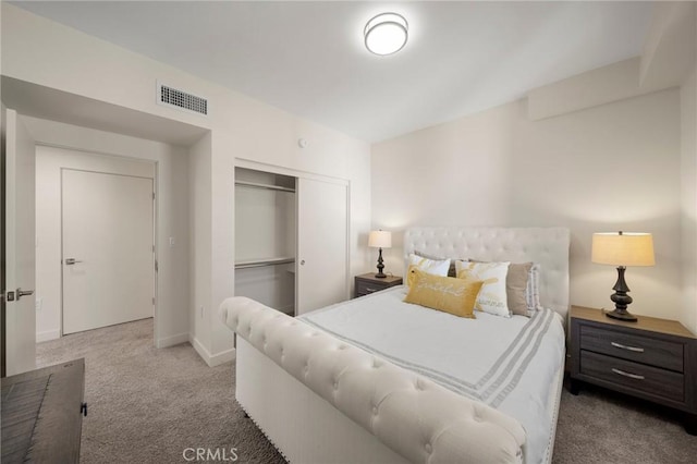 carpeted bedroom with a closet