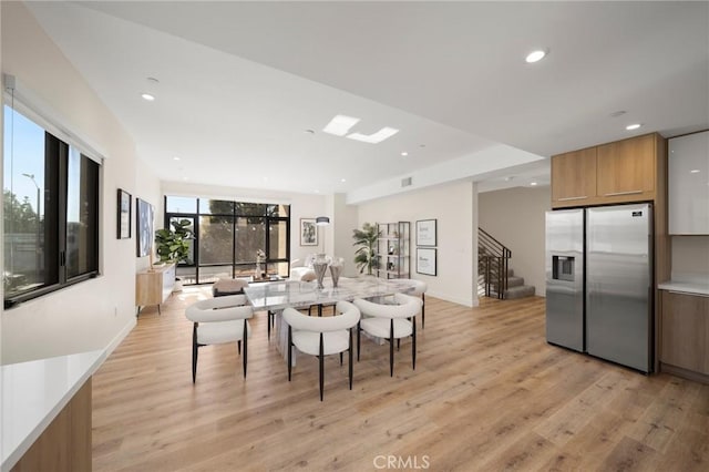 dining space with light hardwood / wood-style floors