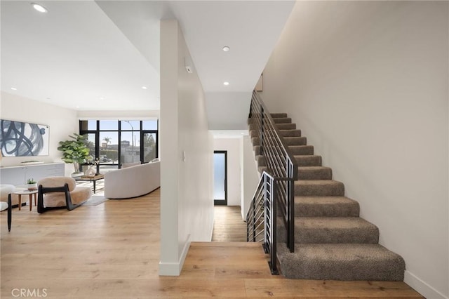 staircase with wood-type flooring