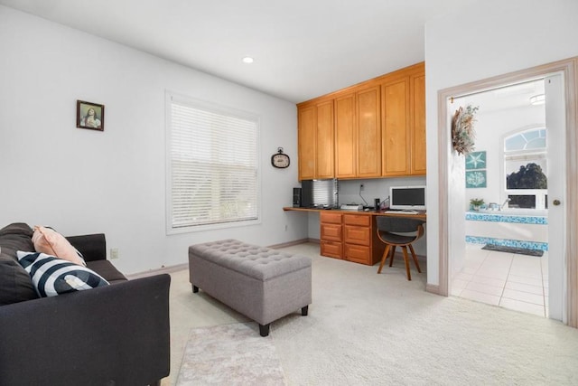 office area featuring light carpet and built in desk