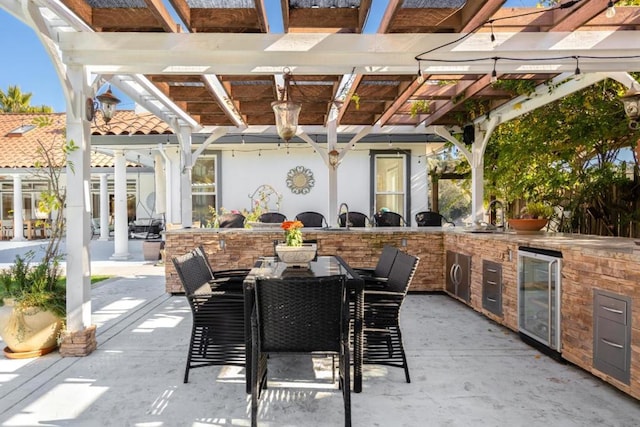 view of patio with area for grilling, sink, and beverage cooler