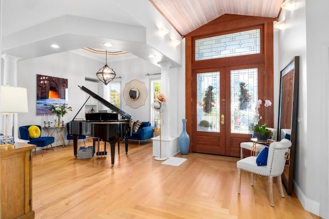 foyer featuring plenty of natural light, parquet floors, an inviting chandelier, and french doors