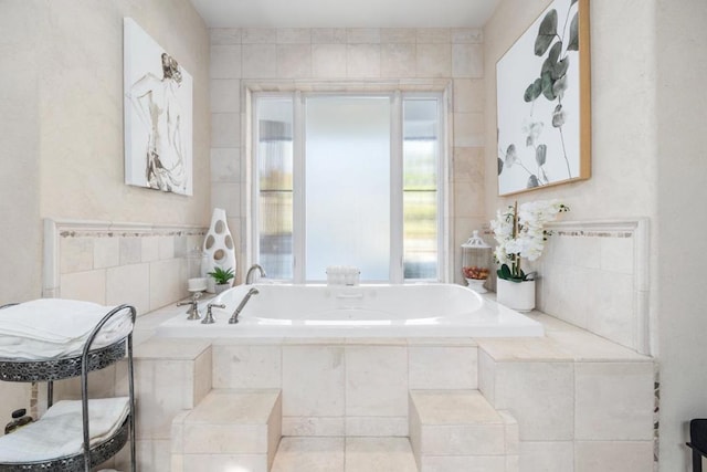 bathroom featuring tiled tub