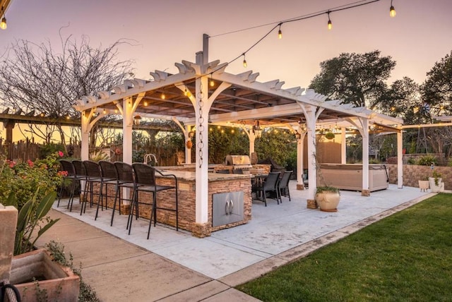 view of property's community with a bar, a hot tub, a pergola, and a patio area