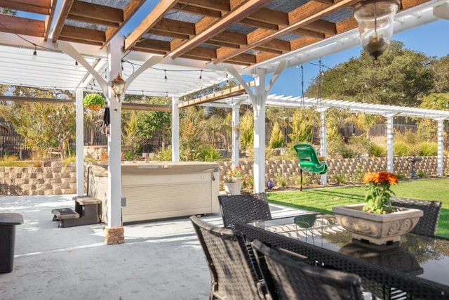 view of patio / terrace with a hot tub and a pergola