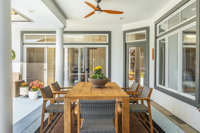 sunroom / solarium featuring ceiling fan and ornate columns