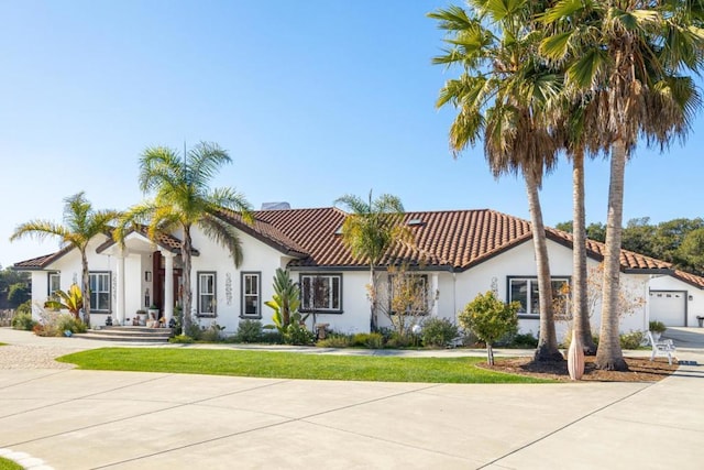 mediterranean / spanish house featuring a front yard