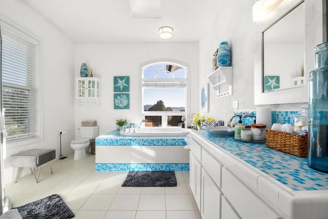 bathroom featuring vanity, tile patterned floors, a bathtub, and toilet