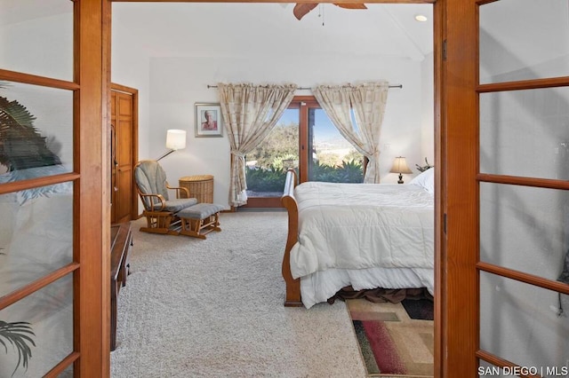 bedroom with ceiling fan, carpet floors, and vaulted ceiling