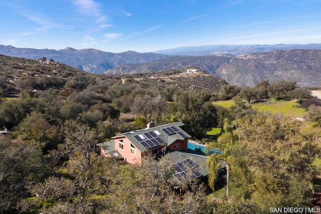 birds eye view of property with a mountain view