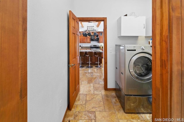 laundry room featuring washing machine and dryer and cabinets