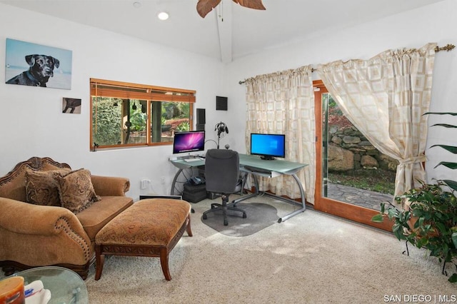 carpeted home office featuring ceiling fan and beam ceiling