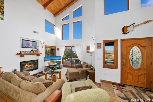 living room featuring high vaulted ceiling, wood-type flooring, beamed ceiling, and wood ceiling